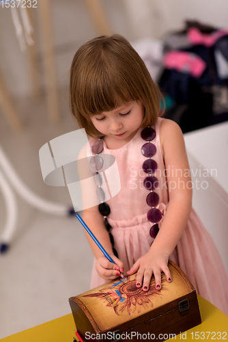 Image of little girl painting jewelry box