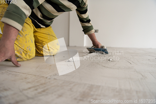 Image of Tilers filling the space between ceramic wood effect tiles