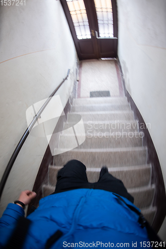 Image of man opening door of a building