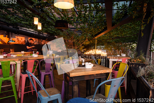 Image of blurred people in cafe decorate with hanging plant