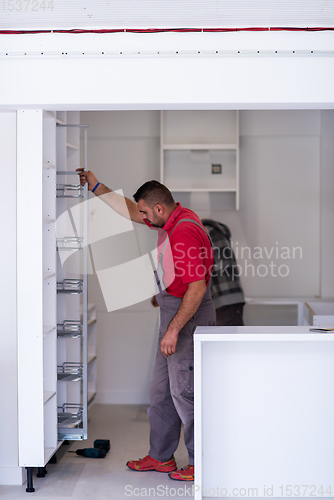 Image of workers installing a new kitchen