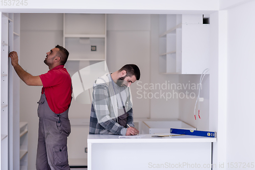 Image of workers installing a new kitchen