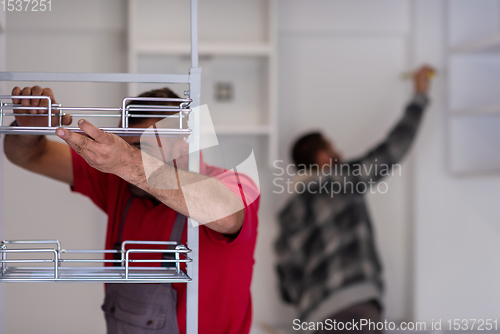 Image of workers installing a new kitchen