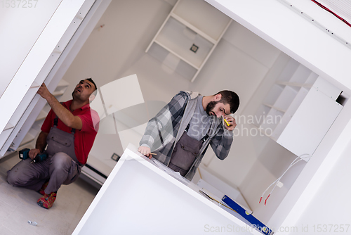 Image of workers installing a new kitchen