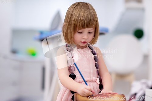 Image of little girl painting jewelry box