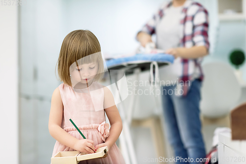 Image of mother and daughter spending time together at home