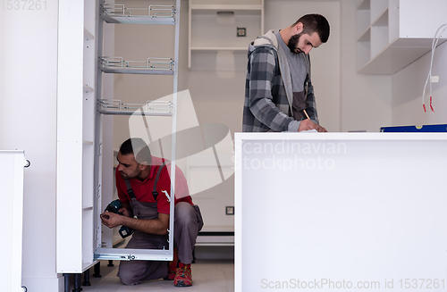 Image of workers installing a new kitchen