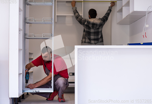 Image of workers installing a new kitchen