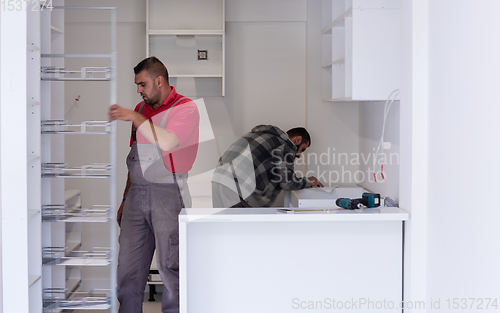 Image of workers installing a new kitchen