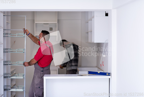 Image of workers installing a new kitchen