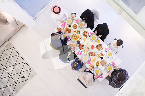Image of traditional muslim family praying before iftar dinner top view