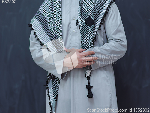 Image of portrait of arabian man in front of black chalkboard