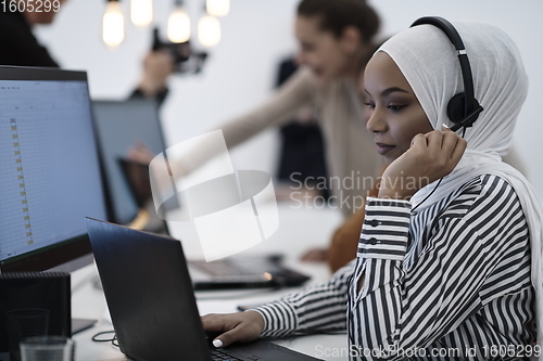 Image of African businesswoman wearing headset in helpdesk