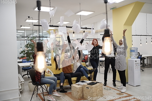 Image of business people throwing paper in air