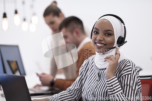 Image of African businesswoman wearing headset in helpdesk