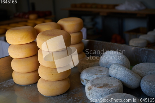 Image of Cheese factory production shelves with aging old cheese