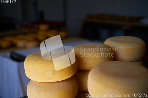 Image of Cheese factory production shelves with aging old cheese