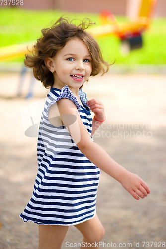 Image of Little girl is playing in playground