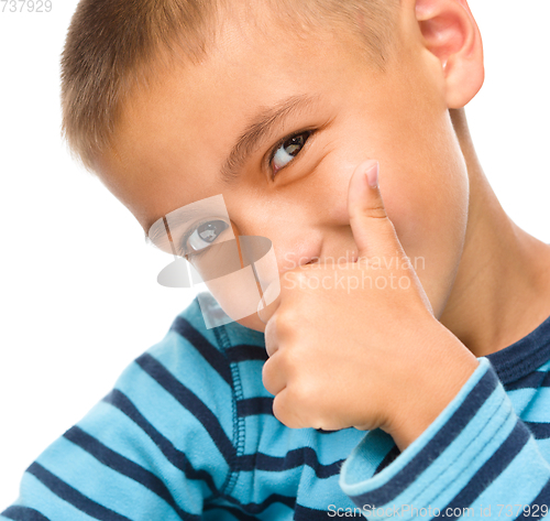 Image of Little boy is showing thumb up sign