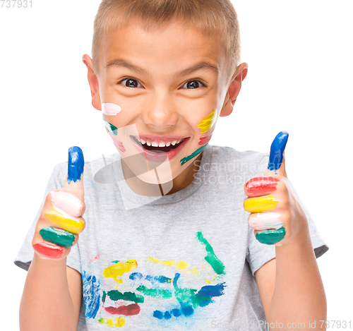 Image of Portrait of a cute boy playing with paints