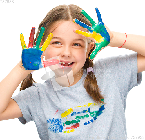 Image of Portrait of a cute girl playing with paints