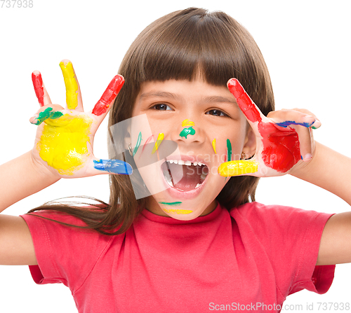 Image of Portrait of a cute girl playing with paints