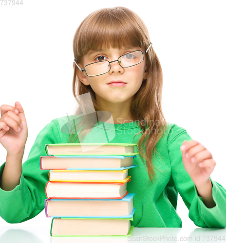 Image of Little girl is reading a book