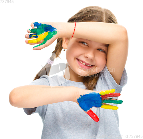 Image of Portrait of a cute girl playing with paints