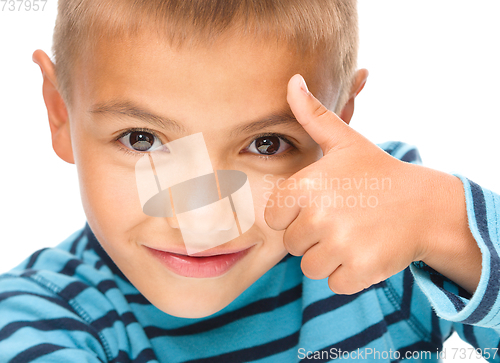 Image of Little boy is showing thumb up sign