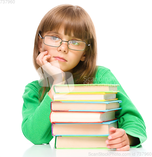 Image of Little girl is reading a book