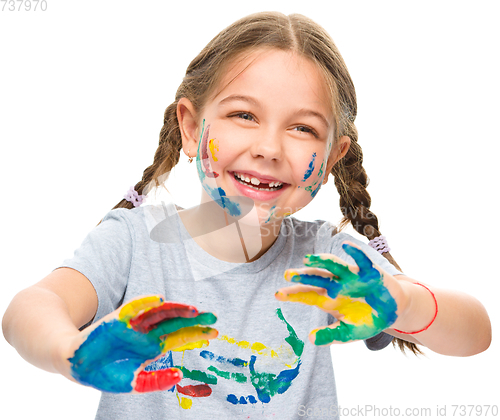 Image of Portrait of a cute girl playing with paints