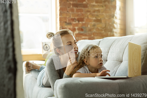 Image of Teacher and little girl, or mom and daughter. Homeschooling concept