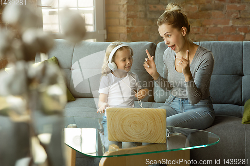 Image of Teacher and little girl, or mom and daughter. Homeschooling concept