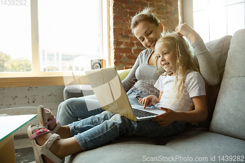 Image of Teacher and little girl, or mom and daughter. Homeschooling concept