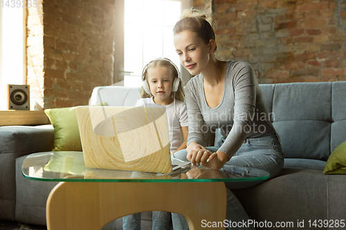 Image of Teacher and little girl, or mom and daughter. Homeschooling concept