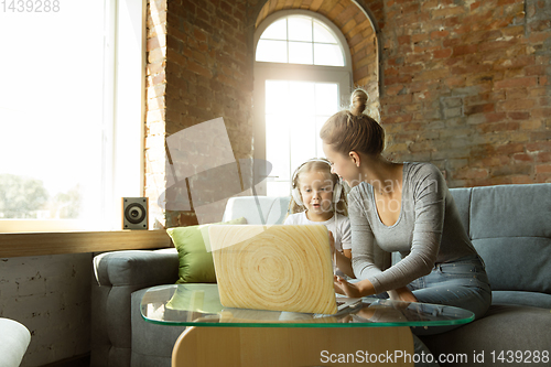 Image of Teacher and little girl, or mom and daughter. Homeschooling concept