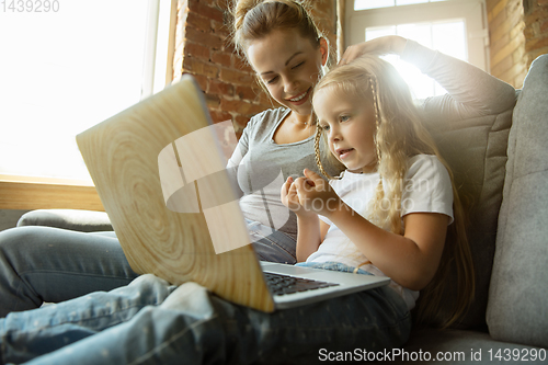 Image of Teacher and little girl, or mom and daughter. Homeschooling concept