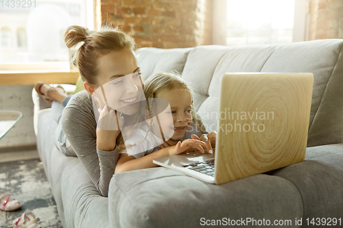 Image of Teacher and little girl, or mom and daughter. Homeschooling concept