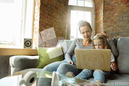 Image of Teacher and little girl, or mom and daughter. Homeschooling concept