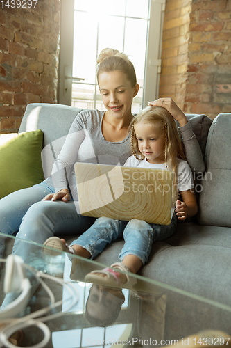 Image of Teacher and little girl, or mom and daughter. Homeschooling concept