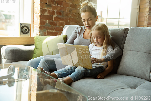 Image of Teacher and little girl, or mom and daughter. Homeschooling concept