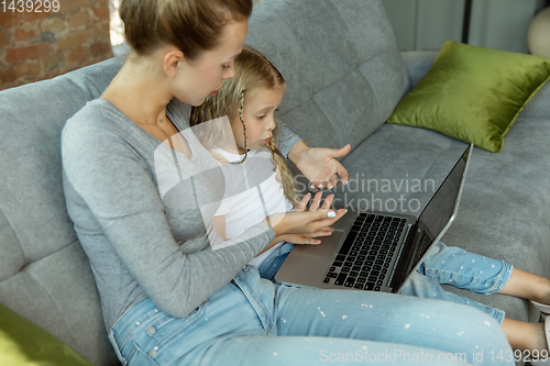 Image of Teacher and little girl, or mom and daughter. Homeschooling concept