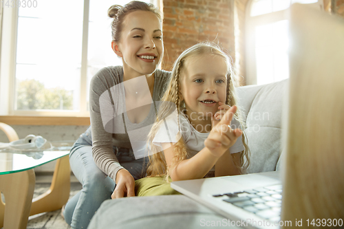 Image of Teacher and little girl, or mom and daughter. Homeschooling concept