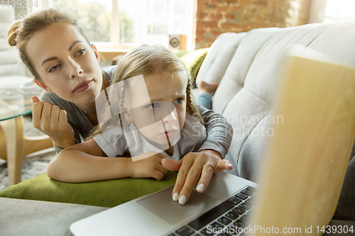 Image of Teacher and little girl, or mom and daughter. Homeschooling concept