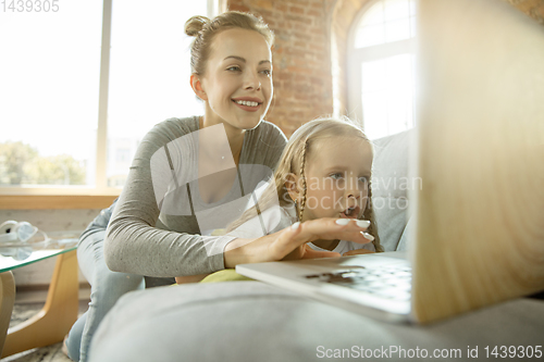 Image of Teacher and little girl, or mom and daughter. Homeschooling concept