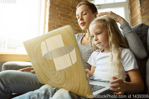 Image of Teacher and little girl, or mom and daughter. Homeschooling concept