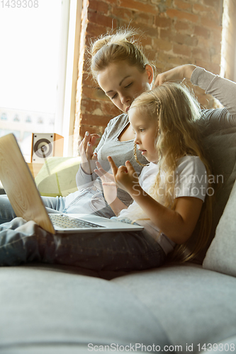 Image of Teacher and little girl, or mom and daughter. Homeschooling concept