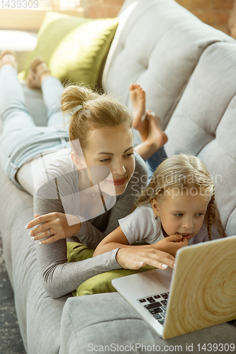 Image of Teacher and little girl, or mom and daughter. Homeschooling concept