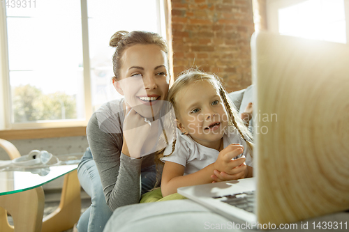 Image of Teacher and little girl, or mom and daughter. Homeschooling concept