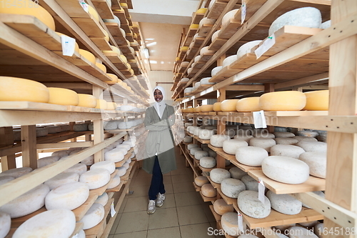 Image of African black muslim business woman in local cheese production company